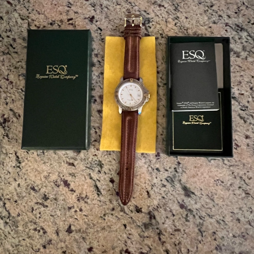 Esquire men’s brown wristwatch , the face of the watch is silver and gold color